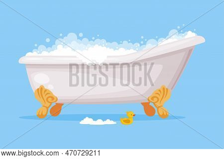 Cast Iron Bathtub On Claw Foot Pedestal Full Of Water With Soap Bubbles Foam Isolated On Blue Backgr