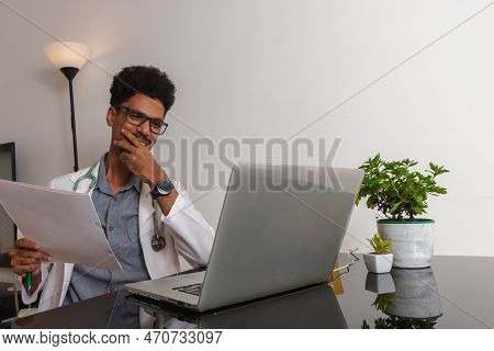 Brazilian Black Doctor Or Veterinarian Working At Home. Young Man Doing Home Office During The Day A