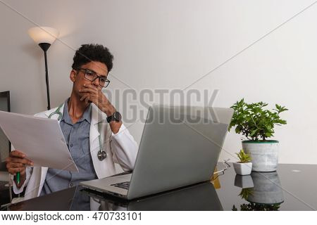 Brazilian Black Doctor Or Veterinarian Working At Home. Young Man Doing Home Office During The Day A