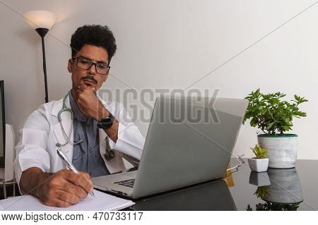 Brazilian Black Doctor Or Veterinarian Working At Home. Young Man Doing Home Office During The Day A