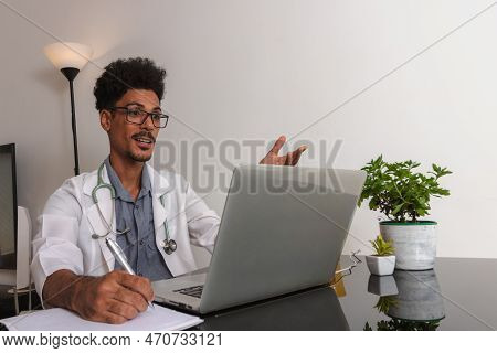 Brazilian Black Doctor Or Veterinarian Working At Home. Young Man Doing Home Office During The Day A