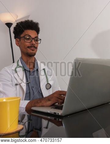 Brazilian Black Doctor Or Veterinarian Working At Home. Young Man Doing Home Office During The Day A