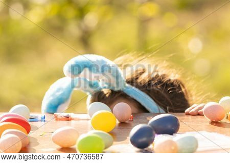 Teenage Girl Paints Easter Eggs In The Garden.