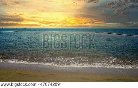 View From Bramston Beach. Stinger Net And Outlaying Island In The Horizon. Sunset And Beautiful Clou