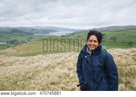 British Asian Indian Woman In Waterproof Coat Hiking In Snowdonia National Park Near Lake Bala, Nort