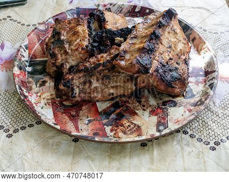 Hot Meat In A Plate Cooked On A Grill On The Grill