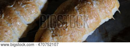 Freshly Cooked Sausage Sausage In Dough With White Sauce On Baking Sheet. Cooked Bun Roll With Stuff