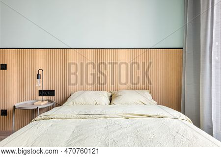 From The Window, Bright Daylight Illuminates The Bedroom With A Mint Wall And Wood Decor. Close-up O