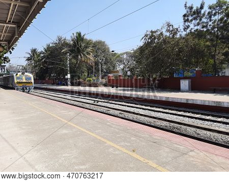Closeup Of Beautiful Mandya Railway Station And Electric Train Moving On A Track.