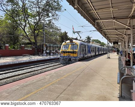 Closeup Of Beautiful Mandya Railway Station And Electric Train Moving On A Track.