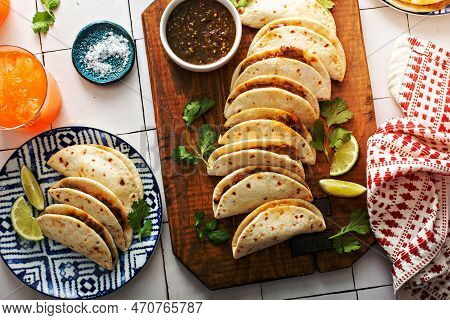 Baked Tacos With Mexican Shredded Beef And Cheese Served With Sour Cream And Salsa