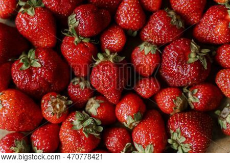 Strawberries In A Basket On Wooden Background.