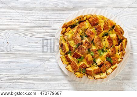 Cheesy Garlic Bread, Pull Apart Whole Round Bread On Platter On White Wood Table, Horizontal View Fr