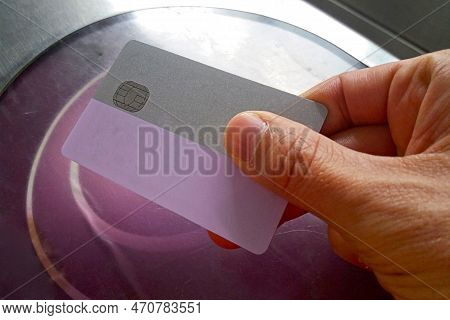 A Man Using It's Subway Pass Card To Travel In Grand Paris. The Pass Allows To Use The Subway But Al
