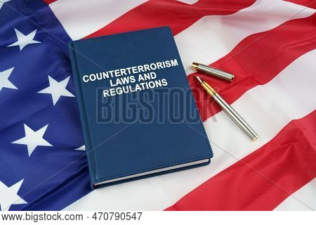 Law Concept. On The Us Flag Lies A Pen And A Book With The Inscription - Counterterrorism Laws And R