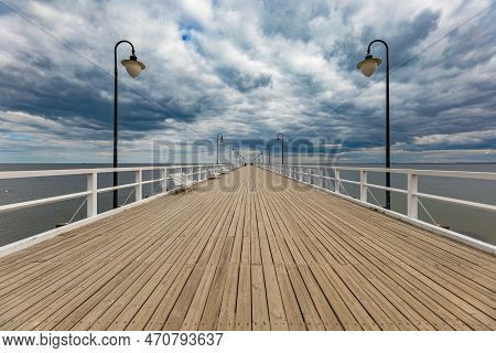 Gdynia, Poland - April 2022: Beautiful Long Wooden Pier With Lamps On Both Sides And Walking People