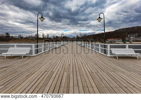 Gdynia, Poland - April 2022: Beautiful Long Wooden Pier With Lamps On Both Sides And Walking People