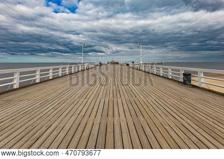 Sopot, Poland - April 2022: Beautiful Long Wooden Pier With Lamps On Both Sides And Walking People
