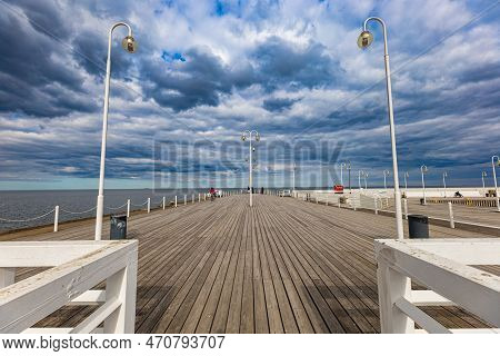 Sopot, Poland - April 2022: Beautiful Long Wooden Pier With Lamps On Both Sides And Walking People