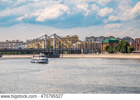 Krymsky Bridge Or Crimean Bridge In Moscow And Cruise Ship Sails On The Moscow River. Steel Suspensi
