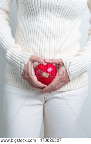 Woman Holding  Red Heart Shape. Pregnancy, Reproductive System, Menstruation, And Gynecology Concept