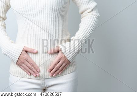 Woman Holding  Her Belly. Pregnancy, Reproductive System, Menstruation, And Gynecology Concept