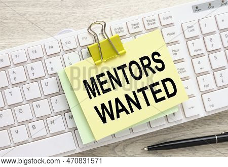 Mentor Wanted Yellow Sticker With A Clip On A White Keyboard. Text In Black