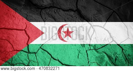 Flag Of  Sahrawi Arab Democratic Republic. Sahrawi Symbol. Flag On The Background Of Dry Cracked Ear