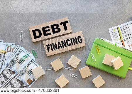 Debt Financing Symbol. Top View On Wooden Blocks. Text In Black Font . Business Finance And Debt Fin