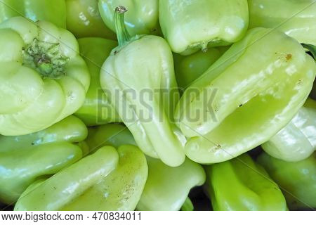 Close-up On A Stack Of White Sweet Pepper (aka: Sweet Slávy) For Sale On A Market Stall.