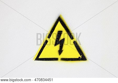 Close-up On An Electricity Hazard Sign Painted With A Stencil On A White Wall.