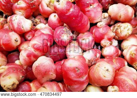 Close-up On A Stack Of Pink Oca (oxalis Tuberosa) On A Market Stall. Oxalis Tuberosa Is A Perennial 