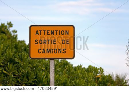Orange Road Sign Stating In French 
