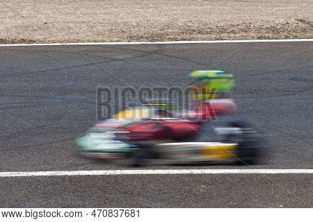 A Go-kart Passing Full Speed With Motion Trail.