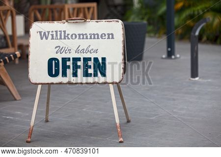 Outdoor Open Sign With Written In It In German: 