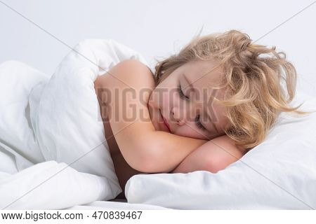 Kid Sleeping In Cozy White Bed. Kid Sleeping On Bed At Home. Bedtime, Kids Sleeps. Child Asleep On P