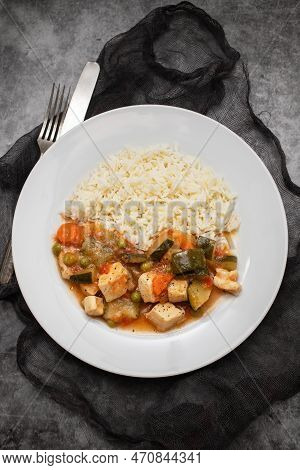 Squid Stew With Vegetables And Boiled Rice On White Plate