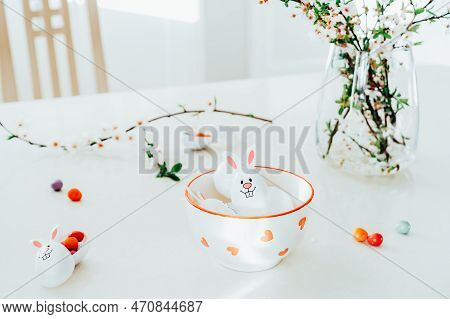Close Up Funny Easter Eggs Containers With Bunny Ears Filled With Candy And Chocolate In A Bowl On T