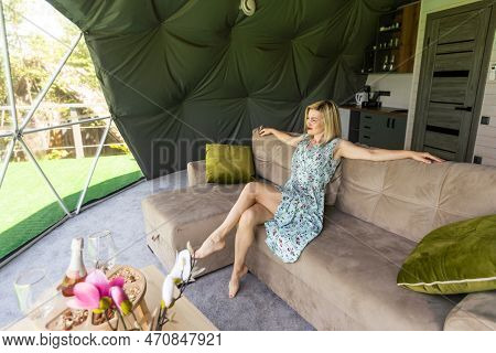 Transparent Bubble Tent At Glamping, Lush Forest Around And Interior. Woman Resting In Glamping