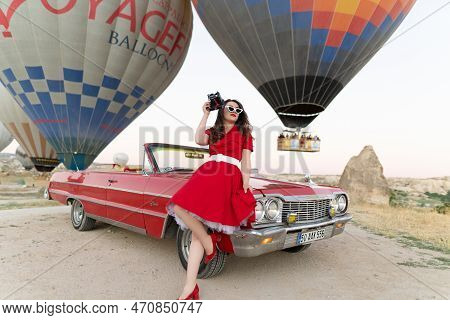 Goreme, Turkey, Cappadocia- June 30, 2021: \\n Beautiful Girl In Retro Style Posing Near A Vintage R