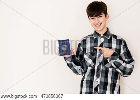 Young Teenager Boy Holding Marshall Islands Passport Looking Positive And Happy Standing And Smiling