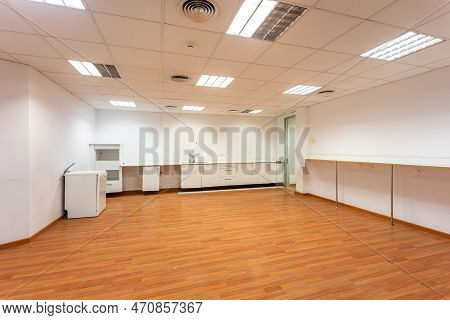 Old Empty Room With White Kitchen Furniture And Sink That Used To Serve As Office Canteen For Employ