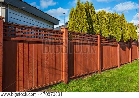 Nice New Wooden Fence Around House. Wooden Fence With Green Lawn. Street Photo, Nobody, Selective Fo