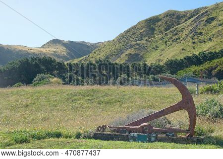 Rusty Old Ships Anchor A Centrepiece At Cape Palliser, North Island, New Zealand.