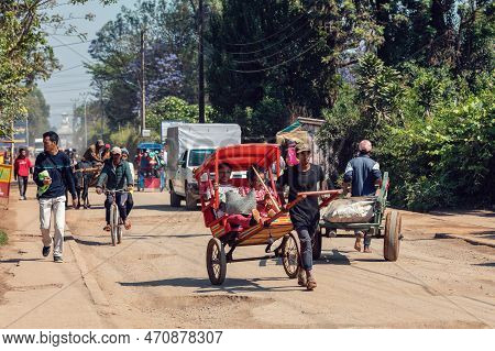 Antsirabe, Madagascar - November 10. 2022: Traditional Rickshaw Bicycle With Malagasy People On The 