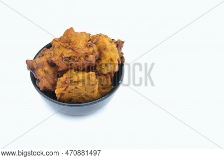 Closeup Of Masoor Dal Pakoda Or Red Lentil Vada In A Black Bowl Isolated On White Background With Co