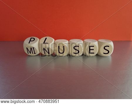 Pluses And Minuses Symbol. Turned  Wooden Cubes And Changes The Word 'minuses' To 'pluses'. Beautifu