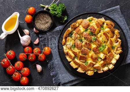Cheesy Garlic Bread, Pull Apart Whole Round Bread On Black Platter On Concrete Table With Melted But