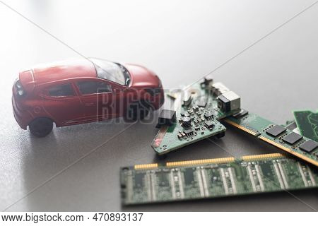 Toy Cars On An Electronic Board With Integrated Circuits. The Shortage Of Microchips And Semiconduct