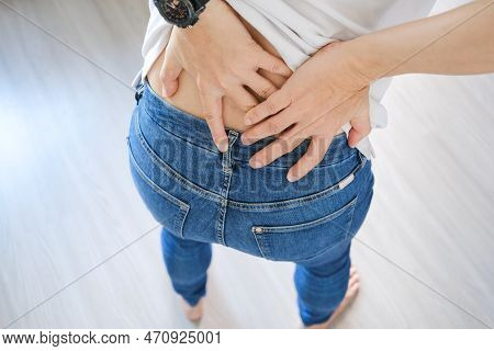 Woman's Hand She Is Caught At The Waist And Her Back Is Painful At The Back In The Park. Cause Of Th